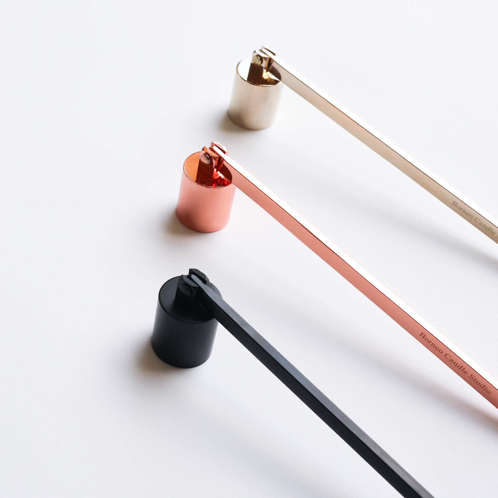 Candle snuffer camdle care accessory in rose gold, gold and black colour